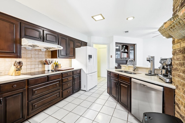 kitchen with white fridge with ice dispenser, stainless steel dishwasher, black electric cooktop, sink, and dark brown cabinets