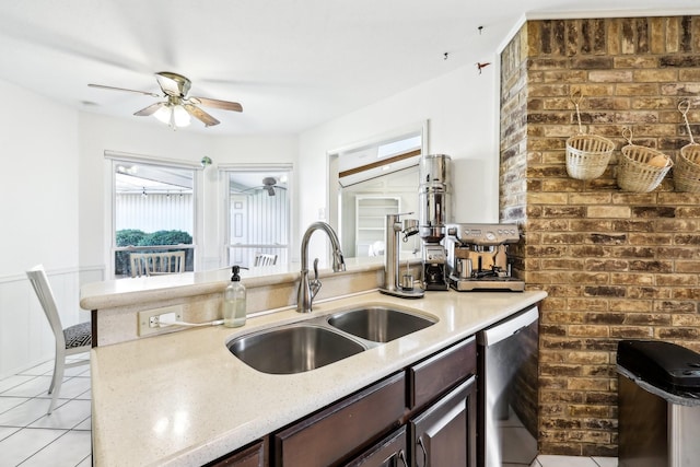 kitchen with stainless steel dishwasher, ceiling fan, sink, light tile patterned floors, and dark brown cabinetry