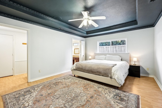 bedroom featuring ceiling fan, crown molding, and a raised ceiling