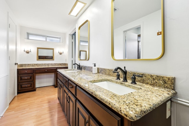 bathroom with hardwood / wood-style flooring and vanity