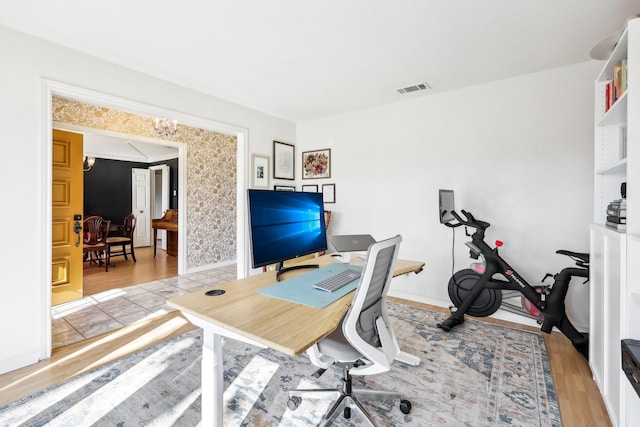 home office with light hardwood / wood-style flooring