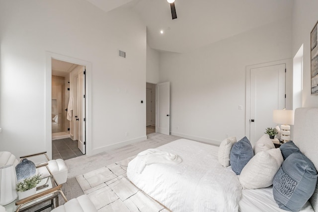 bedroom with high vaulted ceiling, carpet, ensuite bathroom, and ceiling fan