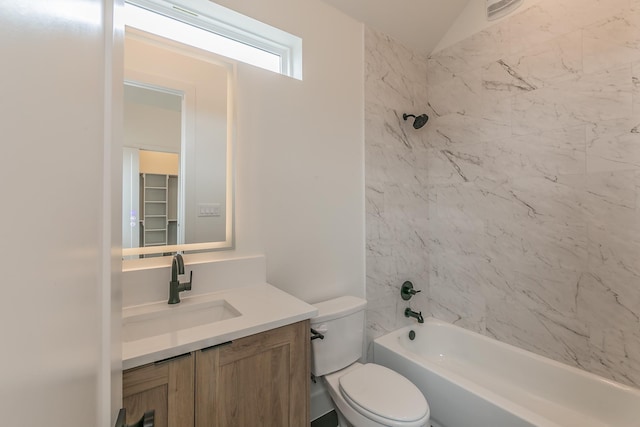 full bathroom with vanity, toilet, vaulted ceiling, and tiled shower / bath combo