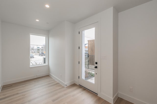 doorway with plenty of natural light and light wood-type flooring