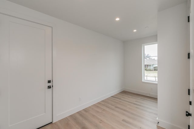 empty room with light hardwood / wood-style flooring