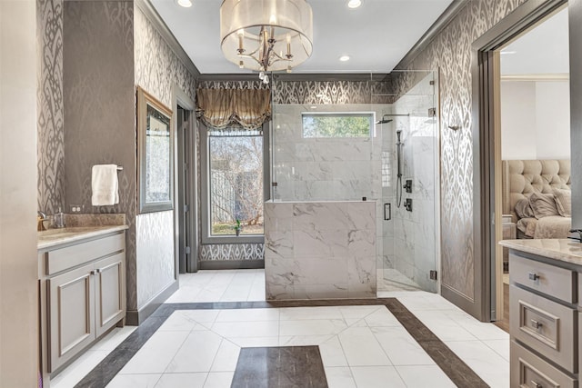 bathroom featuring vanity, a shower with shower door, a notable chandelier, and plenty of natural light