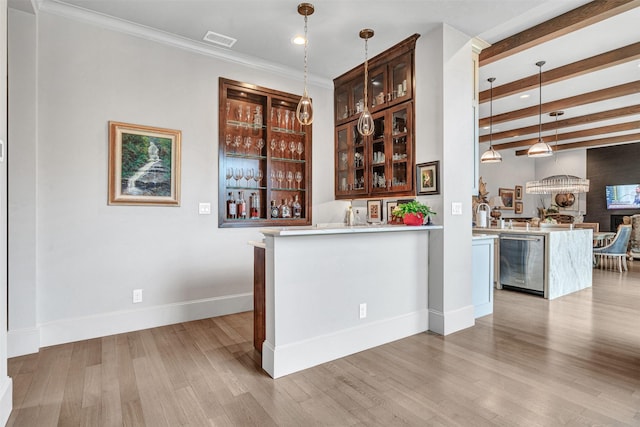 bar featuring light hardwood / wood-style flooring, beam ceiling, hanging light fixtures, and ornamental molding