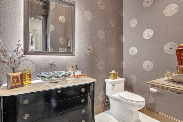 bathroom featuring tile patterned floors, toilet, and vanity