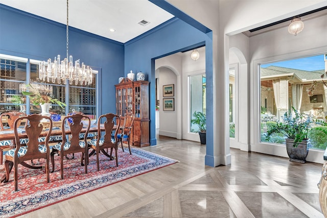 dining space with a chandelier and parquet floors