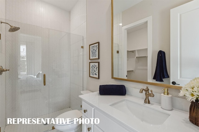 bathroom with vanity, toilet, and an enclosed shower