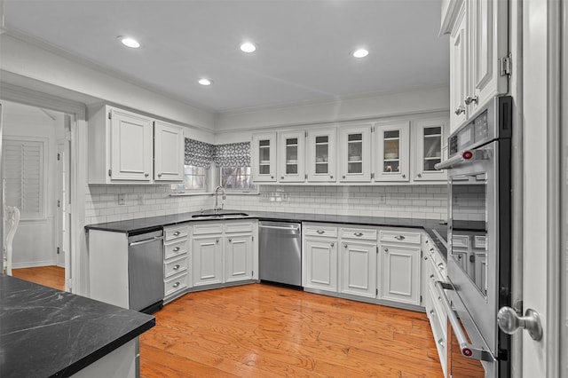 kitchen featuring sink, white cabinetry, and dishwasher