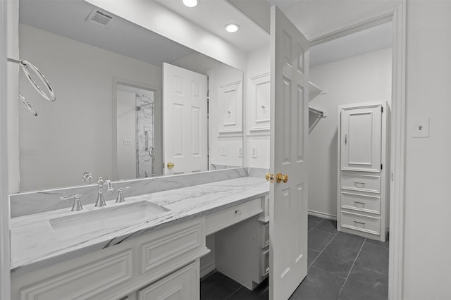 bathroom featuring tile patterned flooring and vanity