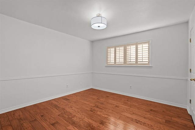 spare room featuring wood-type flooring