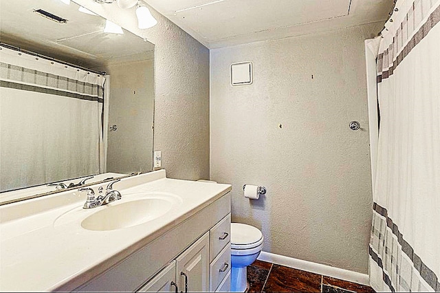 bathroom with vanity, toilet, and tile patterned floors