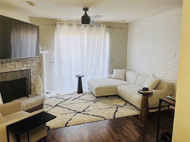 living room with a fireplace, hardwood / wood-style floors, and ceiling fan