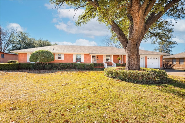 ranch-style home featuring a front yard and a garage