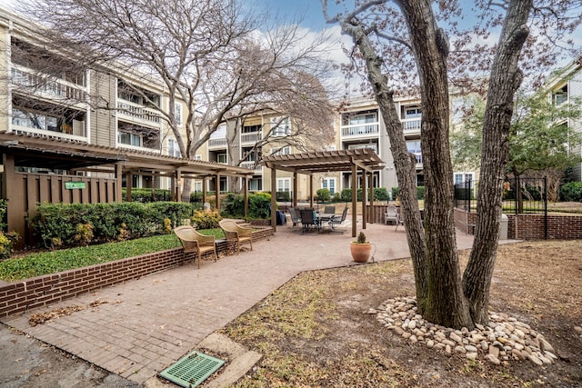 surrounding community with a pergola and a patio area