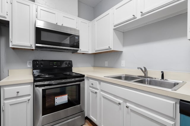 kitchen featuring sink, white cabinets, and appliances with stainless steel finishes