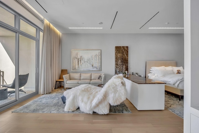 bedroom featuring access to exterior and light hardwood / wood-style flooring