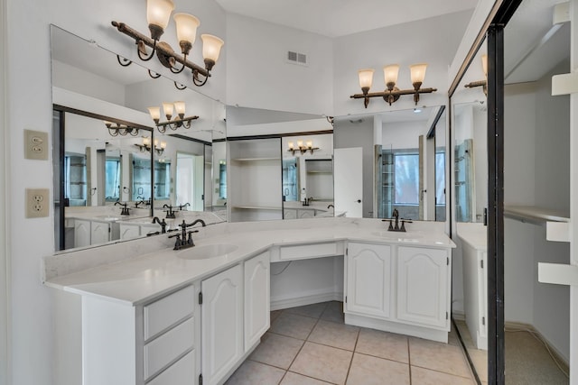 bathroom featuring a chandelier, tile patterned floors, and vanity