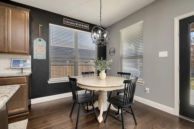 dining room featuring a wealth of natural light and dark hardwood / wood-style floors