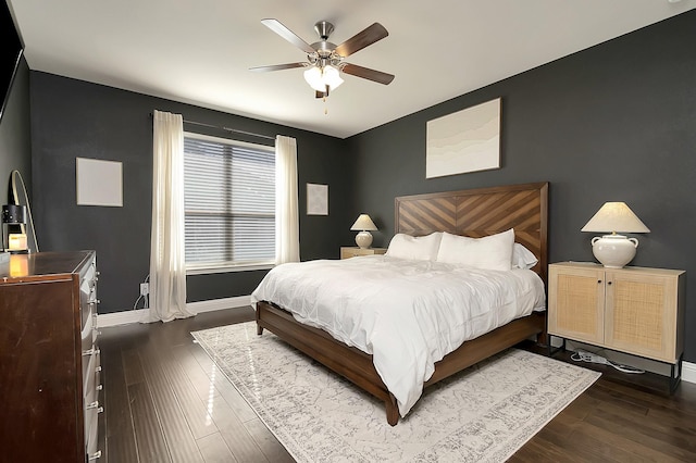 bedroom with dark hardwood / wood-style floors and ceiling fan