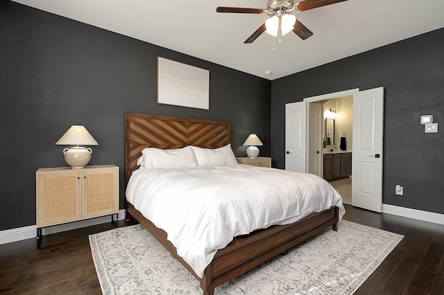 bedroom featuring ensuite bathroom, dark wood-type flooring, and ceiling fan