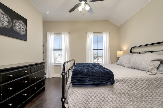 bedroom with dark wood-type flooring, ceiling fan, and vaulted ceiling