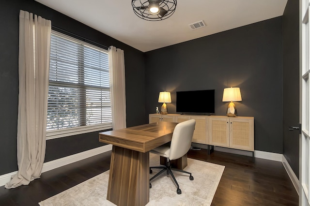 office space with dark wood-type flooring and a healthy amount of sunlight