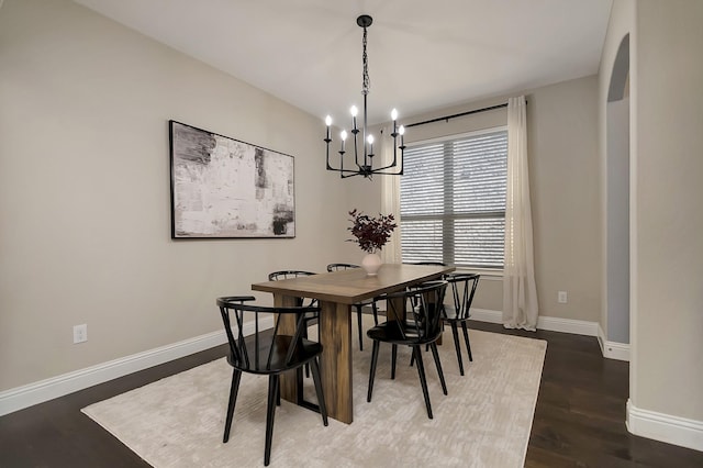 dining room featuring an inviting chandelier and dark hardwood / wood-style floors