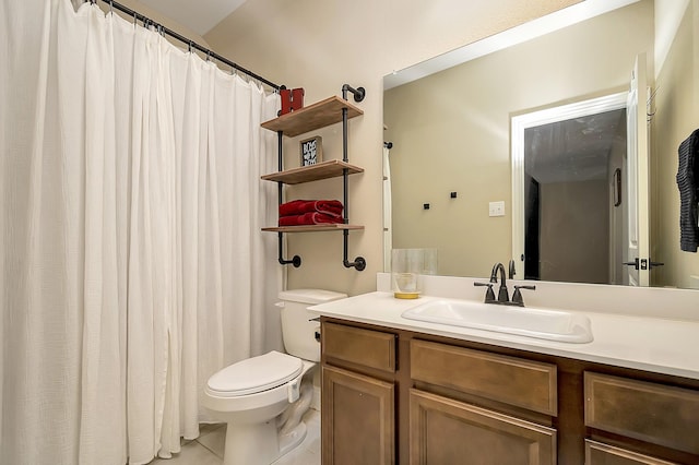 bathroom featuring vanity, toilet, and tile patterned flooring