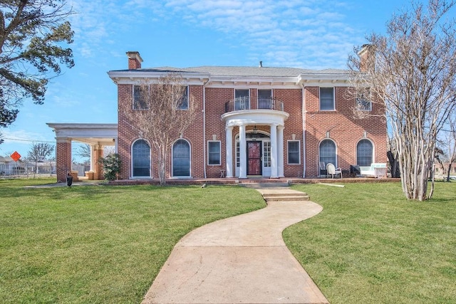 1216 S Colorado St, Coleman, TX 76834 - view of front of property featuring a chimney, a front yard, and brick siding