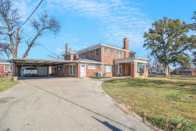 1216 S Colorado St, Coleman, TX 76834 - view of front of property featuring brick siding, a chimney, driveway, a front lawn, and an attached carport