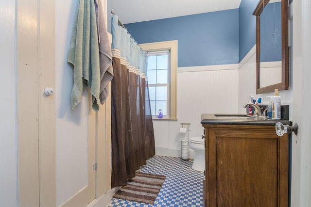 bathroom featuring toilet and vanity