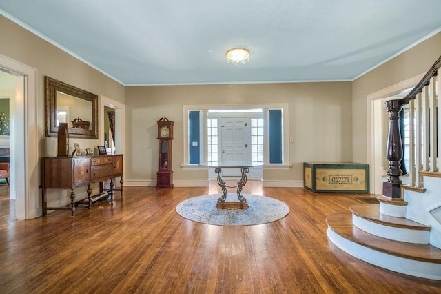 foyer entrance featuring wood-type flooring and ornamental molding