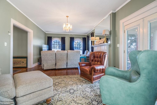 sitting room with hardwood / wood-style floors, crown molding, and a notable chandelier