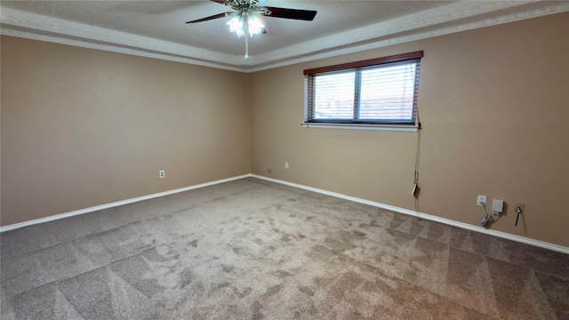 spare room with ceiling fan, carpet, ornamental molding, and a textured ceiling