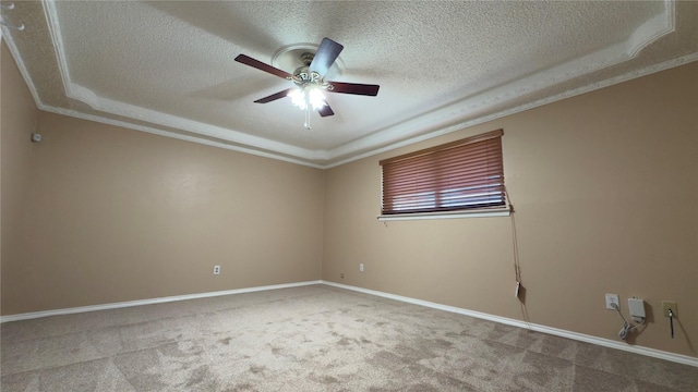 empty room with ceiling fan, carpet, crown molding, and a textured ceiling