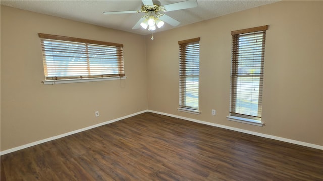 unfurnished room featuring ceiling fan, a textured ceiling, and dark hardwood / wood-style flooring