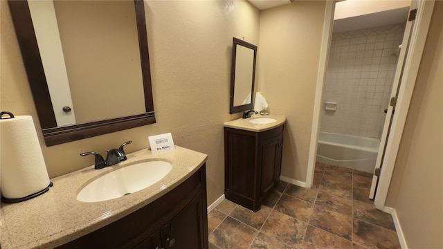 bathroom with vanity and tiled shower / bath