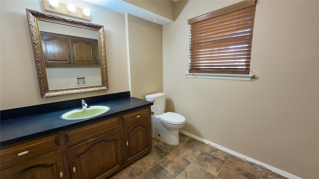 bathroom with toilet and vanity