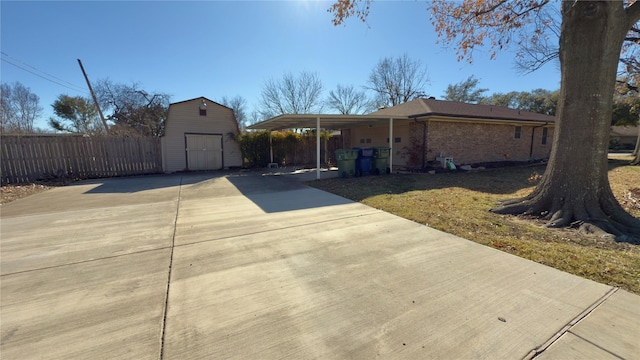 view of front facade featuring a storage shed and a carport