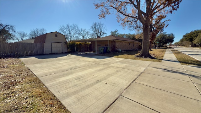 ranch-style house with a carport and a shed