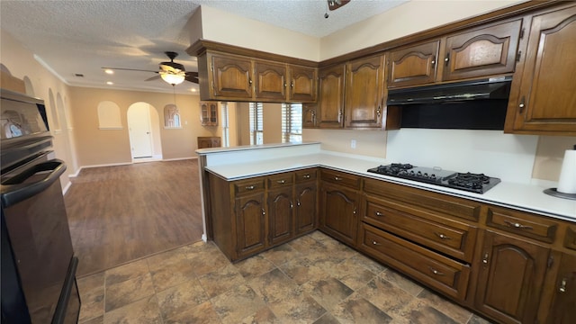 kitchen featuring ceiling fan, a textured ceiling, black appliances, and kitchen peninsula