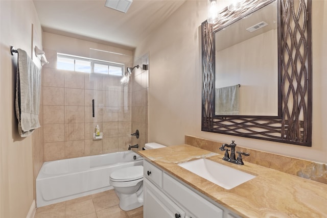 full bathroom featuring toilet, tiled shower / bath, tile patterned flooring, and vanity