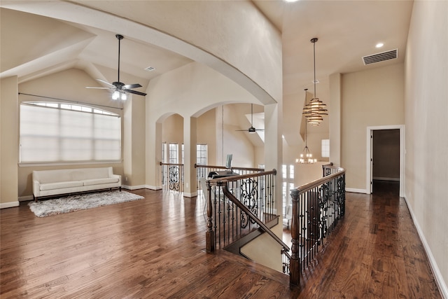 hall featuring a notable chandelier, high vaulted ceiling, and dark hardwood / wood-style floors