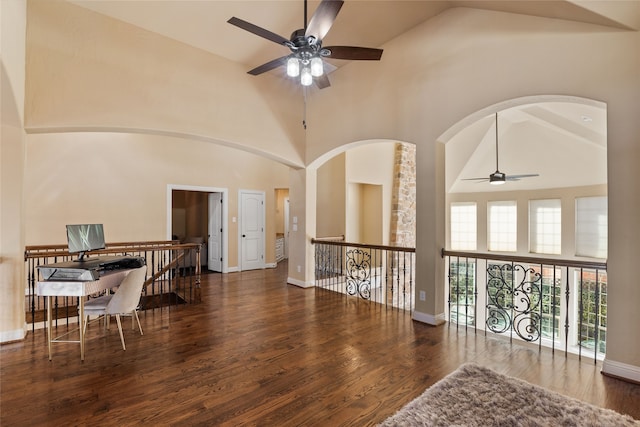 interior space featuring high vaulted ceiling, ceiling fan, and dark hardwood / wood-style flooring