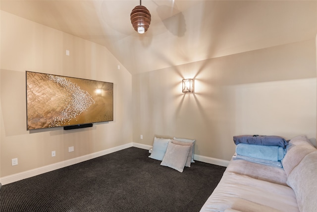 unfurnished room featuring vaulted ceiling and dark colored carpet