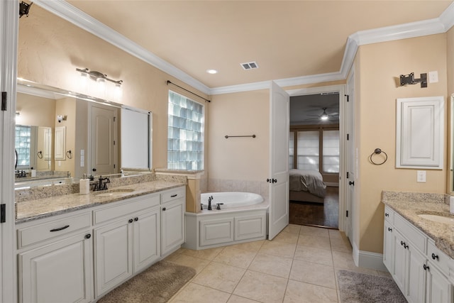 bathroom featuring a bathtub, vanity, crown molding, and tile patterned flooring