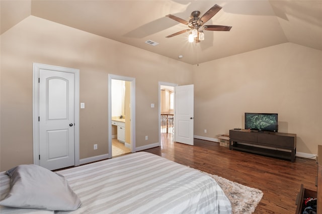 bedroom with dark wood-type flooring, vaulted ceiling, ensuite bath, and ceiling fan